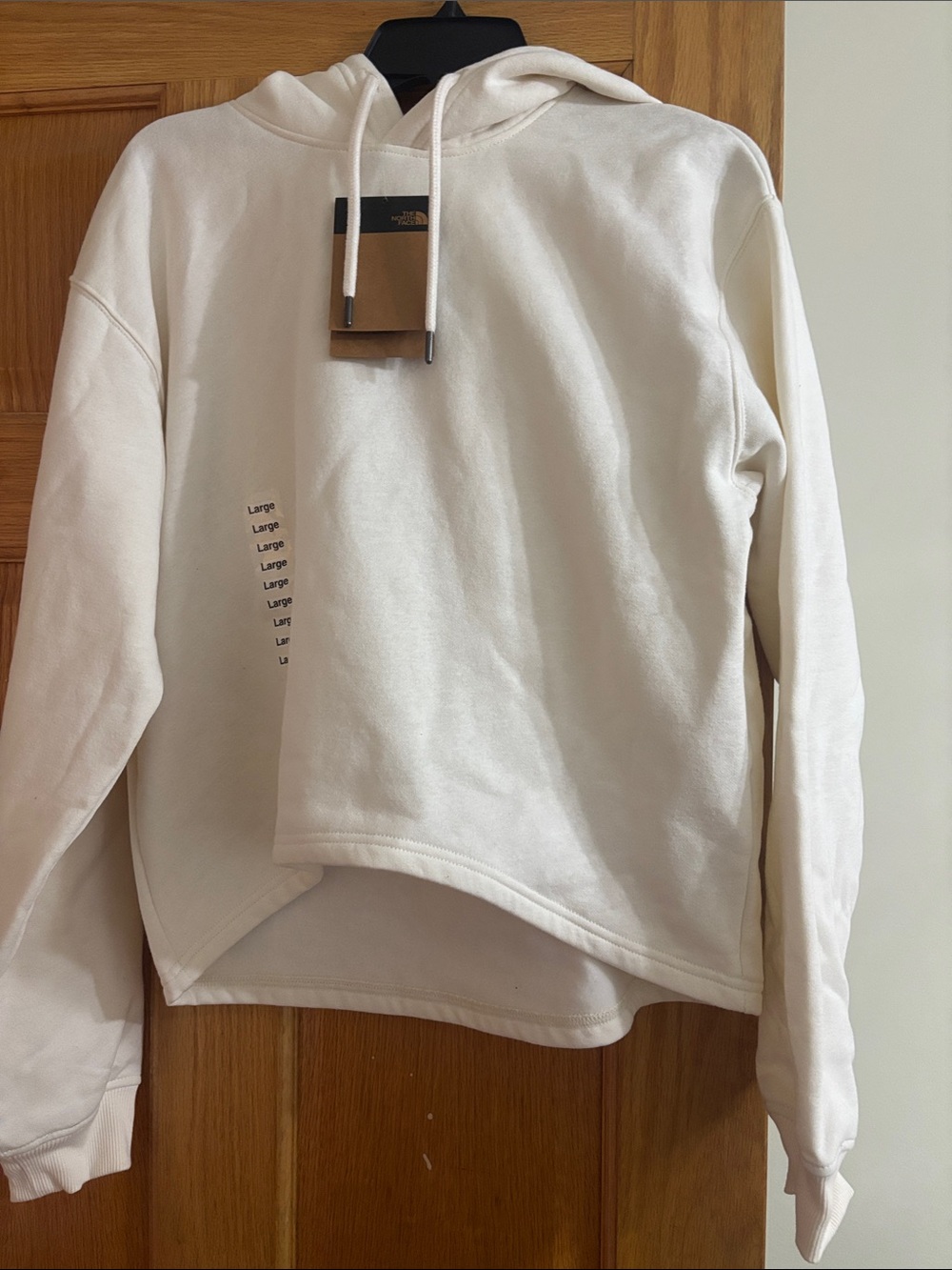 The North Face Off-White Pullover Hoodie with Vertical Logo